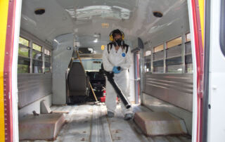 Blowing out the rust inside a bus.