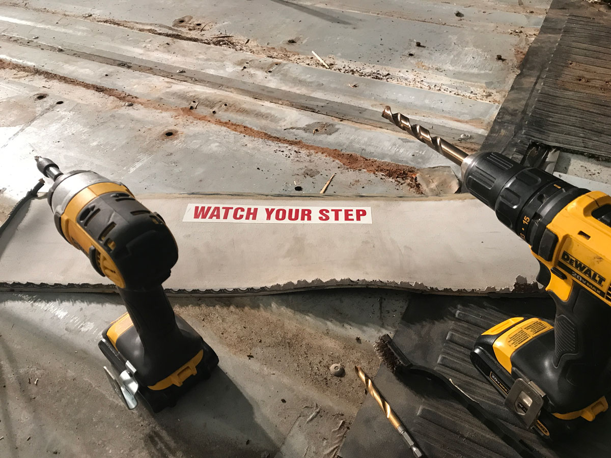 Two drills with a Watch Your Step sign.