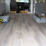 High angle of the new floor with scattered tools and sandbags.