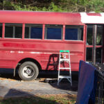 Side shot of bus with no windows.