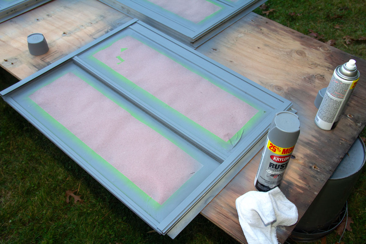 Primed windows on plywood table.