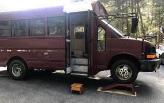 The bus up on ramps.