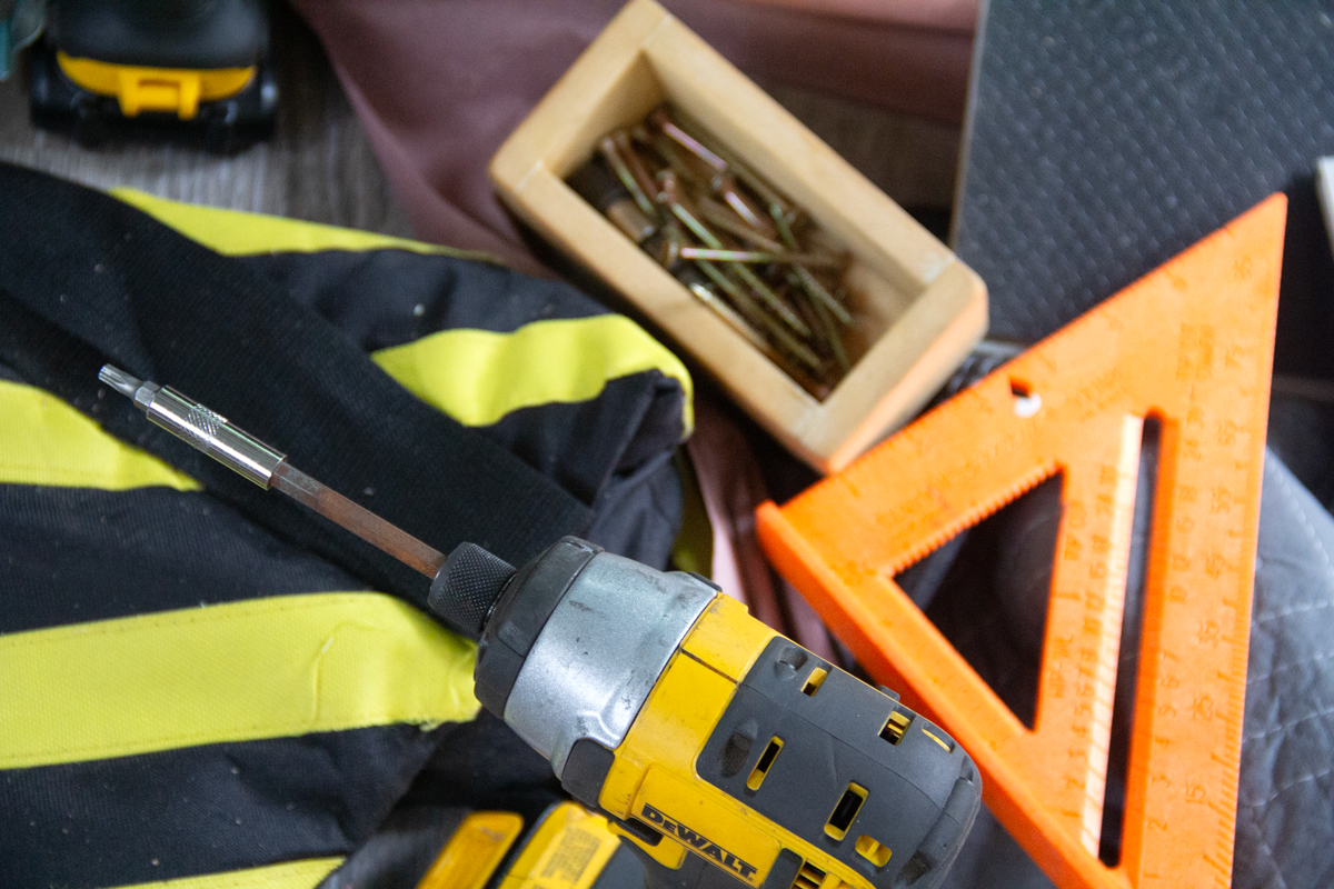 An assortment of tools, including a triangle square.