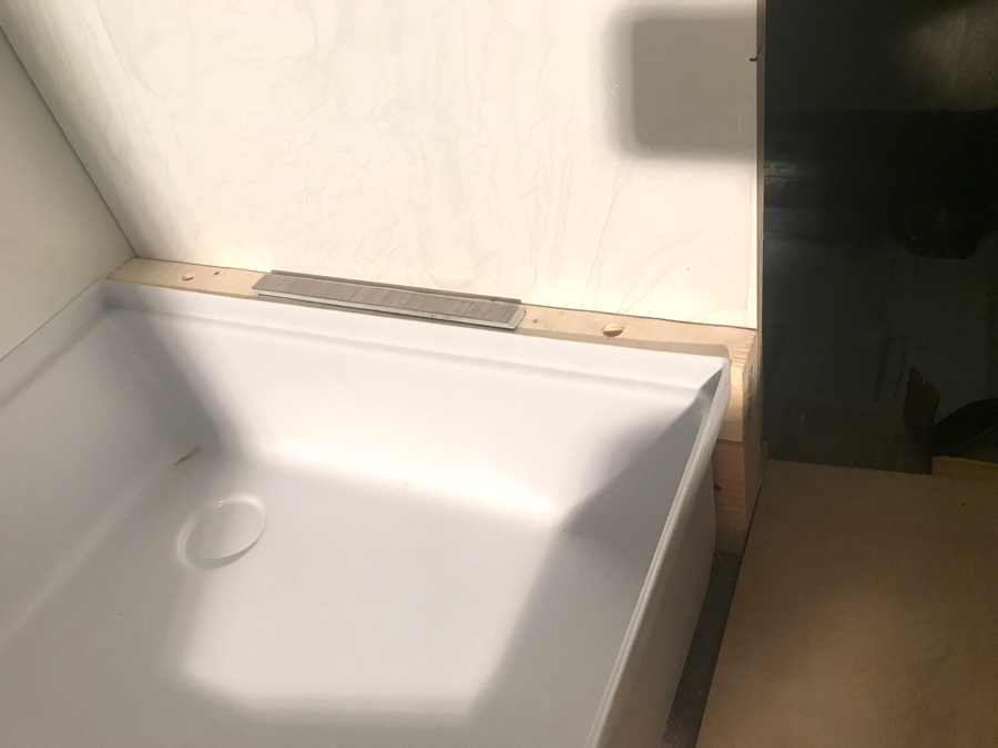 Shower pan before drain was cut.